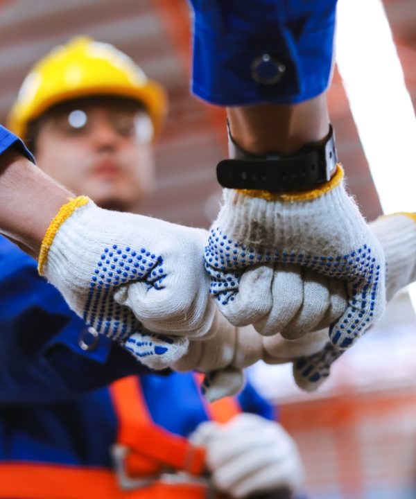 Group,Of,Industrial,Factory,Workers,Bumping,Fists,Together,showing,Gesture,For